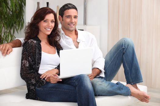 a 35 years old couple sitting on a couch