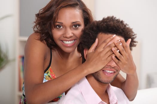 Playful couple relaxing at home