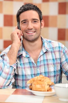 Man on phone at breakfast
