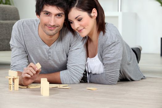 Young man and young woman playing dominoes