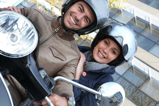 Couple riding a motor bike