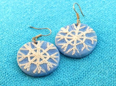clay earrings in winter style handmade on a blue background
