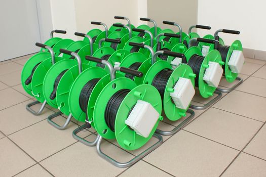 Group of green cable reels for new fiber optic installation