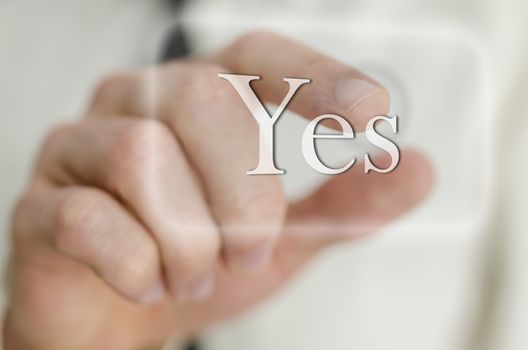 Detail of businessman finger touching a Yes button on a virtual screen