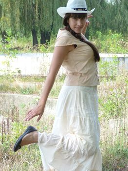 Young brunette girl walks in the park