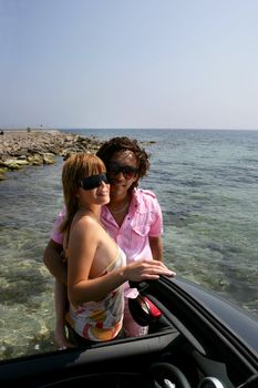 Couple parked next to the ocean