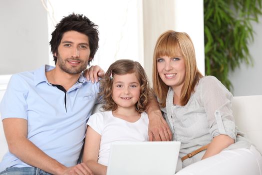 Parents and daughter sat on settee