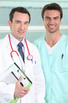 Male doctor and nurse with clipboard