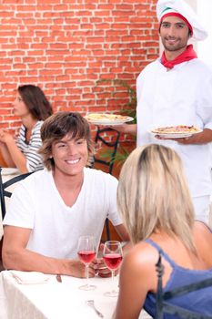 Young couple on a date in a pizzeria.