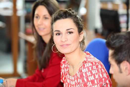 brunette in office with colleagues