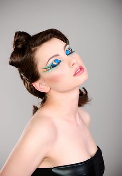 young beautiful woman with extreme makeup studio shot