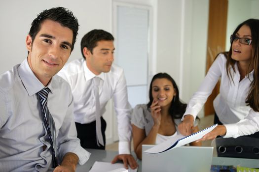 Businessteam gathered around desk