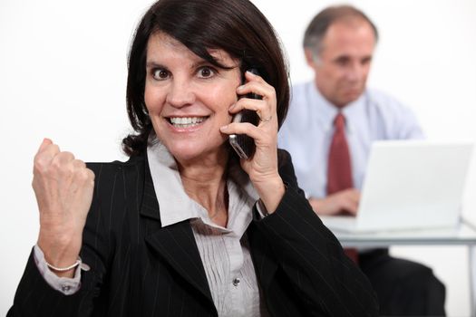 businesswoman talking on phone and receiving very good news