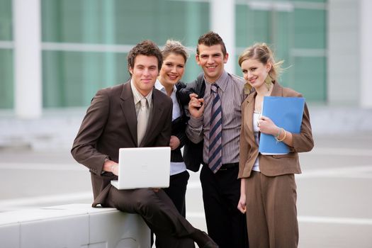 Business team stood outside office block