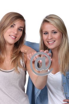 Teenage girls holding @ sign