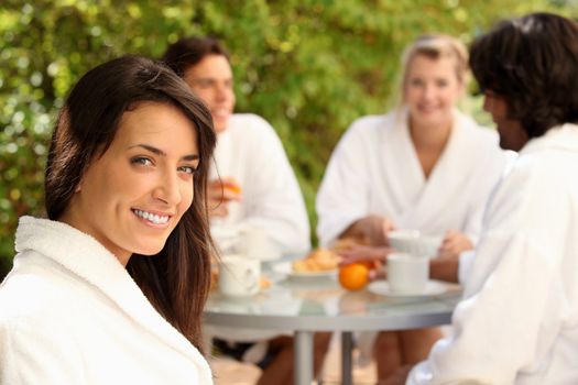 Woman enjoying breakfast outdoors with friends