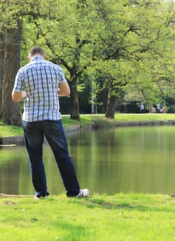 Young and happy family having fun in the park, relaxing, enjoying in beautiful early spring nature.