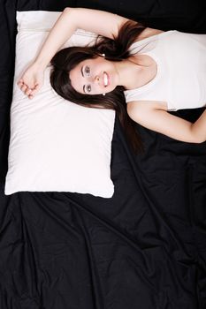 A young hispanic Woman sleeping on the Bed.