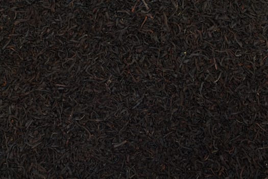 Black tea leaves background. Abstract food textures. 