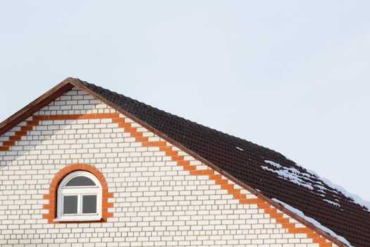 roof brick house on a background of the spring sky