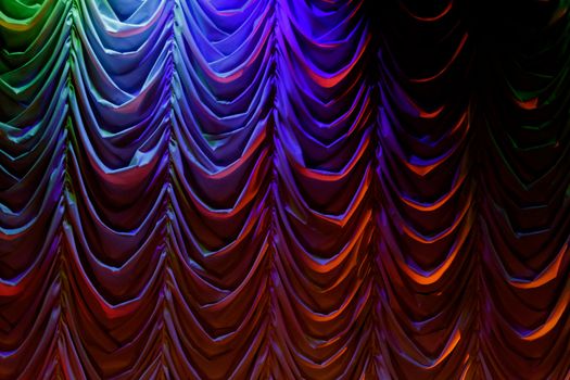 macabre theater curtain with pleats with multicolored lights