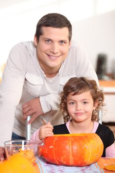 Father and daughter carving pumpkins