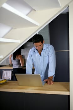 Couple in the kitchen with laptop