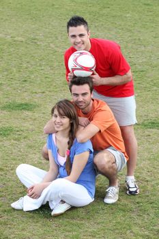 Friends taking a break from playing football