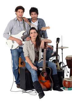 A rock band posing with their instruments