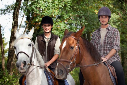 Young people horseriding
