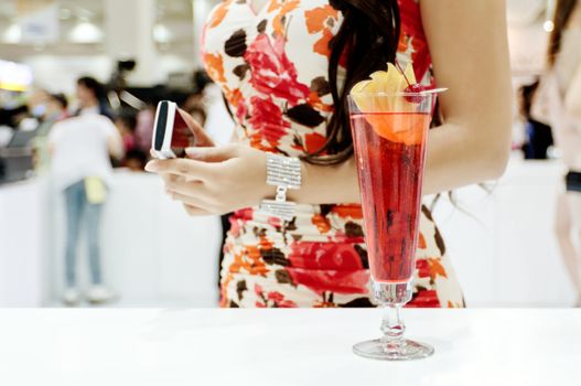 A tall glass of cocktail "Eliza" with a sexy girl on background