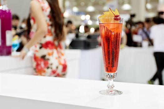 A glass of cocktail "Eliza" with blurry girl on background