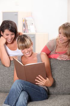 Girls laughing at book