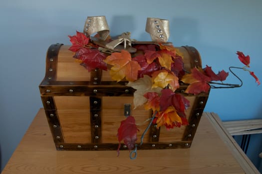 A bride's shoes for an autumn wedding, displayed on a hand-made treasure chest.