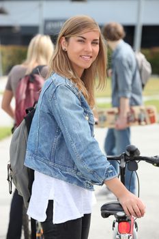 Smiling teenage girl with bicycle