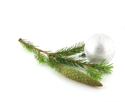 Firry twig and silver sphere over white