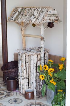 decorative well constructed from pieces of birch