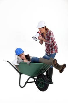 Woman with megaphone yelling at woman asleep