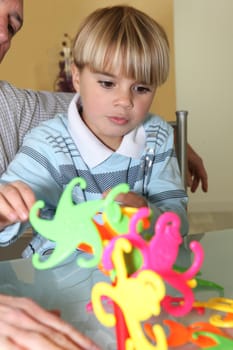 Little boy playing with a colourful toy