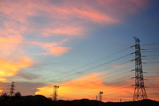 Eletric power post with sunset sky background.