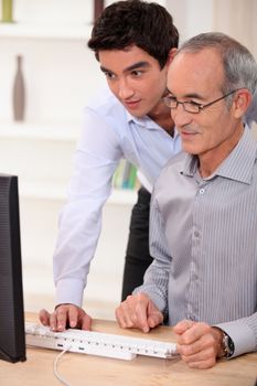 Elderly man learning computer skills