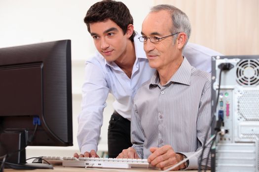 Computer technician helping office worker