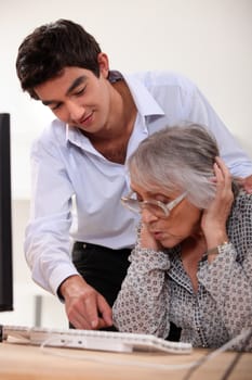 grandson learning his grandmother haw to use a computer