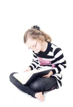 young girl reading a book isolated on white