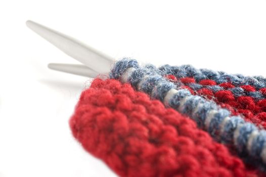 Woolen thread and knitting needle. Needlework accessories on white background.