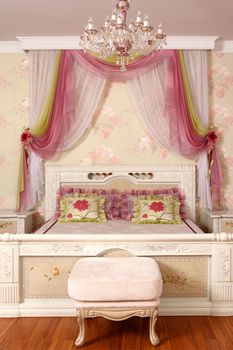 beautiful interior of a bedroom with a bed, a bedside table at a bed and a canopy, a vertical shot