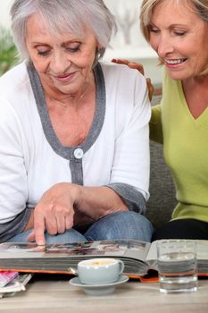 Two women looking through family photo album