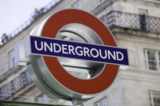 London, United Kingdom - June 8, 2011: London Underground roundel sign against blurred background on June 8, 2011. Recently roundel has been has been applied to other London transport types (taxi, tram, DLR etc.)