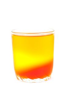 tricolor jelly in a glass on a white background