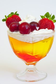 tricolor jelly with whipped cream in a glass 